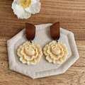 Detailed view of handmade wood and resin flower stud earrings on a linen display mat - Floral Shape (HE32641) / Coffee with Beige
