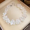 Detail view of a vintage-style white lace choker with intricate glass bead flowers - Necklace-White