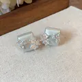 Close-up of pale blue geometric stud earrings with sparkling zircon floral patterns - Geometric Flower Style (HE31343) / Silver Earring Post-Blue