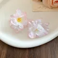 Close-up of elegant peach pink gradient fabric flower hair clips on a white tray - Single Piece / Pink
