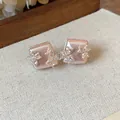 Close-up of rose gold square stud earrings with zirconia flower accents on linen. - Geometric Flower Style (HE31343) / Silver Earring Post - Pink