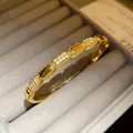 Detail view of 18K gold plated oval bangle with sparkling pave-set cubic zirconia accents - Style 4 / Gold