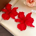 Detailed view of red matte spray-painted floral stud earrings for women vacation style - Red