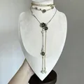 Detailed view of a vintage double-layer necklace with black roses, pearls and tassels. - Double Layer Style / Gold/White/Black