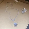 Detailed view of silver waterdrop pendant necklace and matching crystal earrings set - Necklace Earrings Ensemble (Silver) / Clear