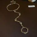 Vintage style gold hand chain with heart resin charms and crystal details on leather - Ring-Linked Bracelet / Gold / White