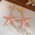Elegant pink and gold enamel starfish drop earrings for a trendy beach vacation style - Starfish Style (HE32834) / Pink