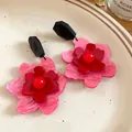 Macro view showing the layered pink and red acrylic flower petals of these retro earrings - Silver Needle / Pink-Red