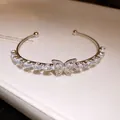Elegant silver-toned open bangle featuring a butterfly motif and water-drop zircon stones - Silver-White