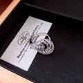 Detailed macro view of a silver-toned twisted ring with sparkling pavé zircon stones - Ring / Silver
