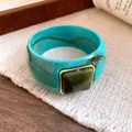 Detailed view of a turquoise marble acrylic bangle with a square green gemstone - Cyan-Green