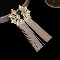 Detailed view of luxury silver flower earrings featuring sparkling rhinestones and long tassels - Silver-White