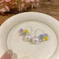 Detailed macro view of elegant curved earrings with white pearl and colorful crystals - Silver Earring Post - Colorful