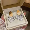 Elegant dual-tone gold and silver heart stud earrings featuring unique hollow lattice design - Open Heart Style / Gold