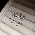 Dettaglio di orecchini d'argento con stelle e perle in un portagioie di velluto - Argento (Perno in argento)
