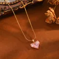 Detail of pink zircon heart pendant on gold snake chain necklace with vintage backdrop. - Gold Pink Rhinestone Heart Snake Chain (24030702)