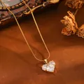 Detailed view of a gold heart pendant necklace with shimmering clear zircon stones. - Gold White Rhinestone Heart Snake Chain (24030702)