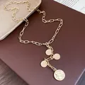 Gold metal chain necklace with multiple coin-shaped portrait pendants on brown leather base. - Portrait Coin Pendant (HN12544) / Gold
