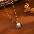 Close-up of elegant pearl pendant with textured gold and black frame - Gold Black Line Artificial Pearl Snake Chain (24030702)