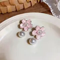 Exquisite detail of pink cherry blossom earrings featuring elegant white pearl drop pendants. - Silver-Pink