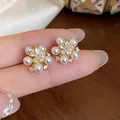 Close-up view of elegant flower stud earrings featuring white pearls and zircons - Five Petal Flower Pearl Inlaid Style