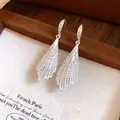 Detailed view of elegant silver lace-pattern drop earrings with zircon embellishments - Hook Style / Silver