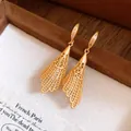 Detailed close-up of golden hollow lace drop earrings with zircon embellishments - Hook Style / Gold