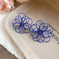 Detailed view of blue wire-wrapped hollow flower stud earrings with silver needles - Dark Blue