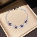 Macro detail of a sparkling silver bracelet with purple and clear zircon stones in a gift box - Style 8 Bracelet / Silver Purple