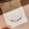 Detail of adjustable silver bracelet with purple and white zircon flower charms. - Style 11 Bracelet / Silver