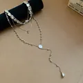 Close-up of silver layered necklace set with irregular water drop pendants. - Four-Piece Set / Silver