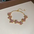Elegant gold bracelet featuring delicate pink cubic zirconia flower clusters for women. - 33# Bracelet / Gold Pink