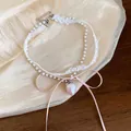 Detail of sweet lace necklace with pink strawberry pendant and silk bow ribbon. - White-Pink