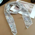 Detail of blue floral mesh neckerchief with lightweight sheer fabric texture. - Gray-Floral Print