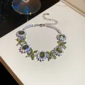 Elegant silver bracelet with sparkling green and white zircons on a white background - 39# Bracelet / Silver/Green