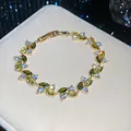 Elegant gold bracelet with sparkling olive green and clear leaf-shaped zircon stones - 47# Bracelet / Gold Olive Green