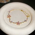 Sparkling pink zircon floral bracelet in gold finish with a delicate adjustable chain. - 54# Bracelet / Gold Pink
