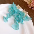 Close-up detail of blue chiffon flower tassel earrings featuring shiny zircon studs - Blue