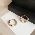 Detailed macro view of 14K gold-plated colorful dopamine enamel patchwork hoop earrings. - Colorful Segmented Enamel Style (HE33077) / Gold
