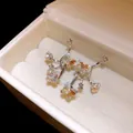 Close-up detail of shimmering crystal butterfly earrings stored in a cream velvet jewelry box - Butterfly Design / Silver