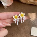 Elegant Korean style white flower stud earrings with yellow center and ribbon bow - White-Yellow