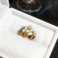Detail of a 18K gold plated ring featuring enamel flowers and sparkling zircons. - 18K Real Gold Plated Style / Gold-White