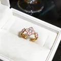 Close-up detail of 18K gold plated ring with pink enamel flower and zircon - 18K Real Gold Plated Style / Gold-Pink