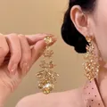 Detail showing the sparkling champagne zircon teardrop tassel earrings on model's ear - Leaf Cut Tassel (4#)