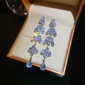 Close-up of elegant zircon water drop tassel earrings in a golden jewelry box - Four-Stage Tassel (37#)