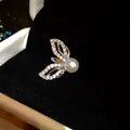 Detailed view of elegant 18k gold plated zircon wings ear cuff featuring a white pearl center. - Silver-Style 5
