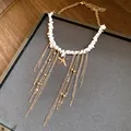 Detailed view of bohemian starfish necklace with white stone beads and gold tassel chains - Starfish Tassel Necklace / Gold-White