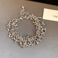 Close-up of vintage silver irregular geometric tassel bracelet with fluid metal design - Bracelet / Silver