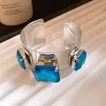 Macro detail of a vintage silver open cuff bracelet featuring large square blue crystal gemstones - Square Rhinestone Open Style (HB5715) / Blue