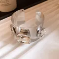 Detailed view of a silver wide cuff bracelet featuring three large square clear crystals - Square Rhinestone Open Style (HB5715) / Silver-Clear